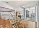 Light-filled dining area with glass table, flows into kitchen and outdoor patio, showcasing open design at 5001 Queen Palm Ne Ter, St Petersburg, FL 33703