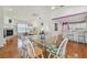 Bright dining room with vaulted ceilings, glass table, and open floor plan to living spaces at 5001 Queen Palm Ne Ter, St Petersburg, FL 33703