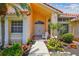 Inviting front entrance with a double door, lush landscaping, and a white Adirondack chair at 5001 Queen Palm Ne Ter, St Petersburg, FL 33703
