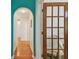 Hallway with wood floors, archway, and access to the office at 5001 Queen Palm Ne Ter, St Petersburg, FL 33703