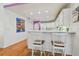 Well-lit kitchen bar area with white cabinets and views into the kitchen's functionality at 5001 Queen Palm Ne Ter, St Petersburg, FL 33703