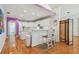 Bright kitchen with white cabinets, bar seating, and hardwood floors, creating an inviting space at 5001 Queen Palm Ne Ter, St Petersburg, FL 33703