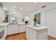 Functional kitchen with a central island, white appliances, and hardwood floors, open to the dining area at 5001 Queen Palm Ne Ter, St Petersburg, FL 33703
