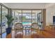 Sunroom with rattan chairs offering views of the screened-in pool area at 5001 Queen Palm Ne Ter, St Petersburg, FL 33703