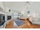 Inviting living room with hardwood floors, featuring a corner fireplace, large window and neutral decor at 5001 Queen Palm Ne Ter, St Petersburg, FL 33703