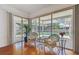 Sun-filled room with seating facing screened-in pool and backyard at 5001 Queen Palm Ne Ter, St Petersburg, FL 33703