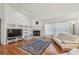 Cozy living room featuring a fireplace, built-in shelving, and a large window for natural light at 5001 Queen Palm Ne Ter, St Petersburg, FL 33703