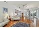 Spacious living room with hardwood floors and an open floor plan, leading to the dining area and kitchen at 5001 Queen Palm Ne Ter, St Petersburg, FL 33703