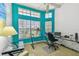 Bright office space with a large window, a glass desk, and a ceiling fan at 5001 Queen Palm Ne Ter, St Petersburg, FL 33703