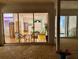 Inviting patio with wicker seating, offering a view of the home's interior and bright office space at 5001 Queen Palm Ne Ter, St Petersburg, FL 33703