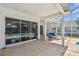 Covered patio with brick flooring, screened-in pool area, and comfortable seating at 5001 Queen Palm Ne Ter, St Petersburg, FL 33703