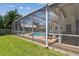 Well-maintained pool area with a screened enclosure, brick patio, and lush landscaping, perfect for outdoor enjoyment at 5001 Queen Palm Ne Ter, St Petersburg, FL 33703