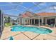 Gorgeous pool area featuring a screened enclosure, brick patio, and comfortable seating, perfect for relaxation and fun at 5001 Queen Palm Ne Ter, St Petersburg, FL 33703
