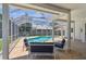 Stunning pool area featuring a screened enclosure, brick patio, and comfortable seating arrangements for outdoor relaxation at 5001 Queen Palm Ne Ter, St Petersburg, FL 33703