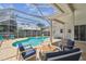 Beautiful screened-in pool with a brick-paved patio and comfortable seating, ideal for relaxing and entertaining outdoors at 5001 Queen Palm Ne Ter, St Petersburg, FL 33703