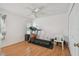 Minimalist spare room with laminated wood flooring, a ceiling fan, and a treadmill for fitness at 5001 Queen Palm Ne Ter, St Petersburg, FL 33703