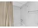 Bathroom featuring a shower-tub combo with white tile and bright lighting at 5095 Bay Ne St # 210, St Petersburg, FL 33703
