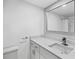 Bathroom with bright vanity featuring modern fixtures, bright lighting, and a large mirror at 5095 Bay Ne St # 210, St Petersburg, FL 33703