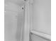Clean bathroom with white tile shower featuring a curtain, and a low flow toilet at 5095 Bay Ne St # 210, St Petersburg, FL 33703