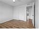 Bedroom featuring wood-look floors, neutral paint, and a double-door closet at 5095 Bay Ne St # 210, St Petersburg, FL 33703