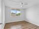 Bright bedroom featuring wood-look floors, neutral paint, and a community view at 5095 Bay Ne St # 210, St Petersburg, FL 33703