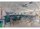 Bright clubhouse featuring tile floors, ceiling fans, and numerous tables and chairs for gatherings and activities at 5095 Bay Ne St # 210, St Petersburg, FL 33703