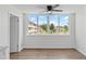Bright room showcasing large windows, neutral finishes, ceiling fan and beautiful sunny skies at 5095 Bay Ne St # 210, St Petersburg, FL 33703