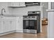 Close up of updated kitchen featuring stainless steel oven, white cabinets, and gray countertops at 5095 Bay Ne St # 210, St Petersburg, FL 33703