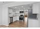 Updated kitchen featuring stainless steel appliances, white cabinets, granite countertops, and wood-look floors at 5095 Bay Ne St # 210, St Petersburg, FL 33703