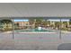 Relax at the community pool, complete with lounge chairs, palm trees, and a covered patio at 5095 Bay Ne St # 210, St Petersburg, FL 33703