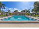 Sparkling community pool with ample deck space and lounge chairs under a clear blue sky at 5095 Bay Ne St # 210, St Petersburg, FL 33703