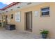 View of the outside bathhouse with a potted plant adding a touch of greenery, and posted pool rules at 5095 Bay Ne St # 210, St Petersburg, FL 33703