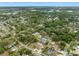 Aerial view of home in a lush green neighborhood with access to the water at 534 Berkley Ave, Tarpon Springs, FL 34689