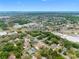 An expansive aerial view showcases the location of a single-Gathering home, surrounded by lush foliage and the distant cityscape at 534 Berkley Ave, Tarpon Springs, FL 34689