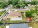 Aerial view of a yellow house with fenced yard and a patio area; storage container in the back at 534 Berkley Ave, Tarpon Springs, FL 34689