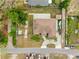 Aerial view of property showing the roof, backyard patio with green space, driveway, and surrounding neighborhood at 534 Berkley Ave, Tarpon Springs, FL 34689