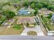 Bird's eye view of a property featuring a spacious yard, circular driveway, and well-maintained landscaping at 534 Berkley Ave, Tarpon Springs, FL 34689