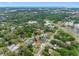 High aerial shot of the single-Gathering home nestled in a lush, green neighborhood close to commercial and residential areas at 534 Berkley Ave, Tarpon Springs, FL 34689