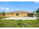 Spacious backyard featuring a large patio, screened-in porch, and well-maintained lawn, perfect for outdoor gatherings at 534 Berkley Ave, Tarpon Springs, FL 34689