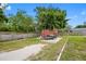Well-maintained backyard with mature trees, a storage container, and ample space, perfect for outdoor enjoyment at 534 Berkley Ave, Tarpon Springs, FL 34689
