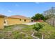Large backyard with a patio and mature trees offers privacy and space for outdoor activities and relaxation at 534 Berkley Ave, Tarpon Springs, FL 34689