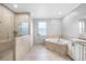 Bright bathroom with dual head shower, soaking tub, and granite vanity at 534 Berkley Ave, Tarpon Springs, FL 34689