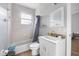 Bathroom with a vanity, toilet, bathtub, shower, and window for natural light at 534 Berkley Ave, Tarpon Springs, FL 34689