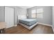 Bedroom featuring wood-look floors, a neutral color scheme, and a large window at 534 Berkley Ave, Tarpon Springs, FL 34689
