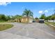 Circular driveway leads to a charming home with a well-manicured yard, offering ample parking and curb appeal at 534 Berkley Ave, Tarpon Springs, FL 34689