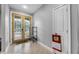 Bright entryway with a decorative glass front door, tile flooring, and a coat closet at 534 Berkley Ave, Tarpon Springs, FL 34689