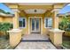 Inviting front entrance with decorative doors, stylish columns, and stone pathway at 534 Berkley Ave, Tarpon Springs, FL 34689