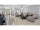 Open-concept living room with tile flooring, neutral walls, and multiple seating areas at 534 Berkley Ave, Tarpon Springs, FL 34689