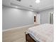 Spacious bedroom featuring neutral walls, wood floors, and an ensuite bathroom at 534 Berkley Ave, Tarpon Springs, FL 34689