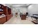 Bright office with neutral walls, tile floor, built in shelves and a window at 534 Berkley Ave, Tarpon Springs, FL 34689